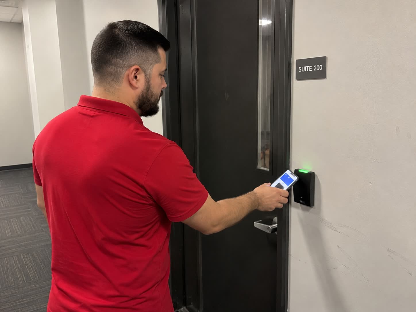 Unlocking a suite door with a phone at a Bluetooth reader